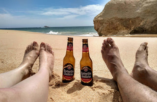 Liming in Grenada - Couple on beach with beers