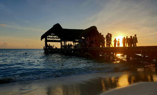 People liming on a boardwalk in Guyana