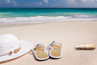 Sandals and sun hat on the beach